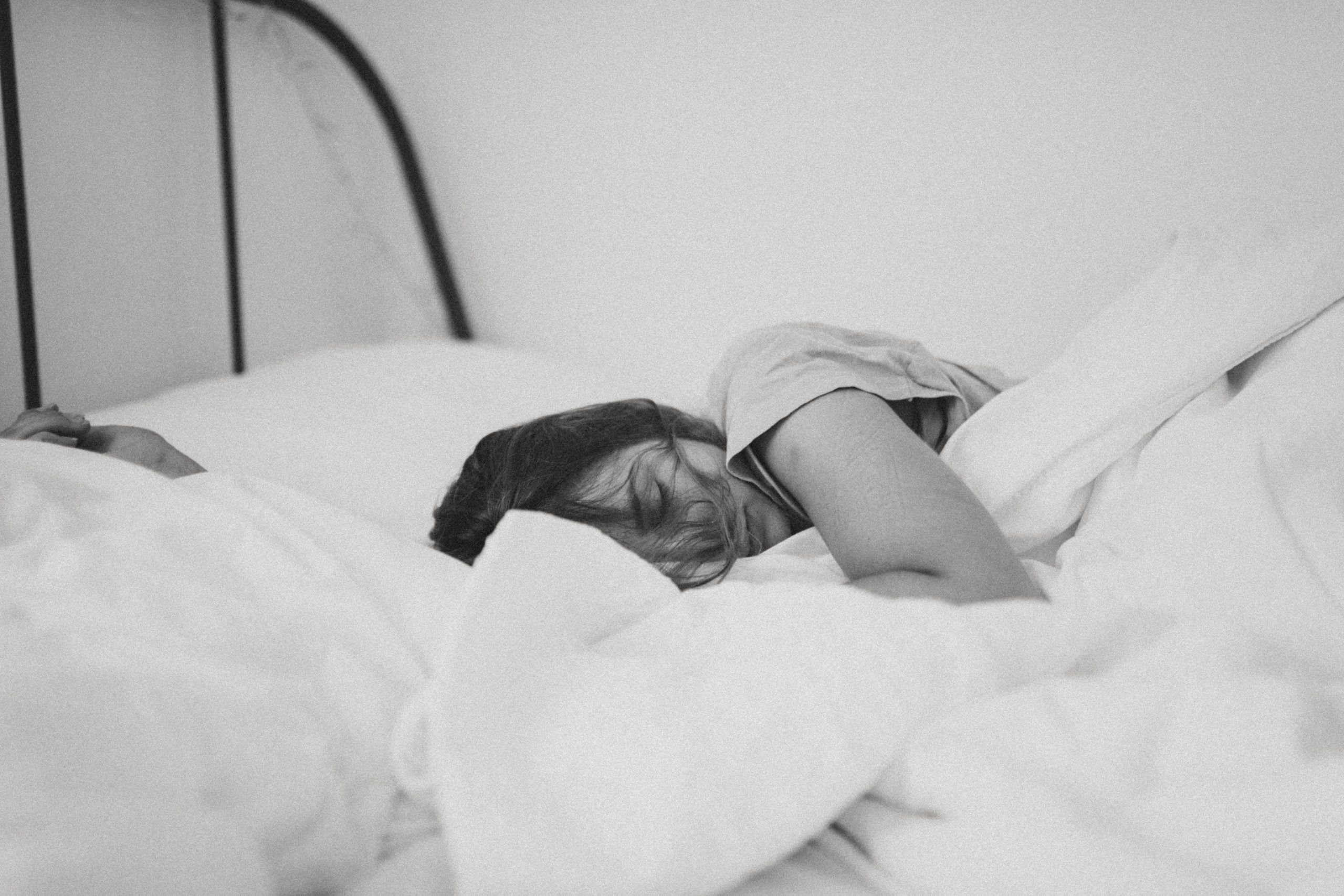 Woman in bed with post viral fatigue